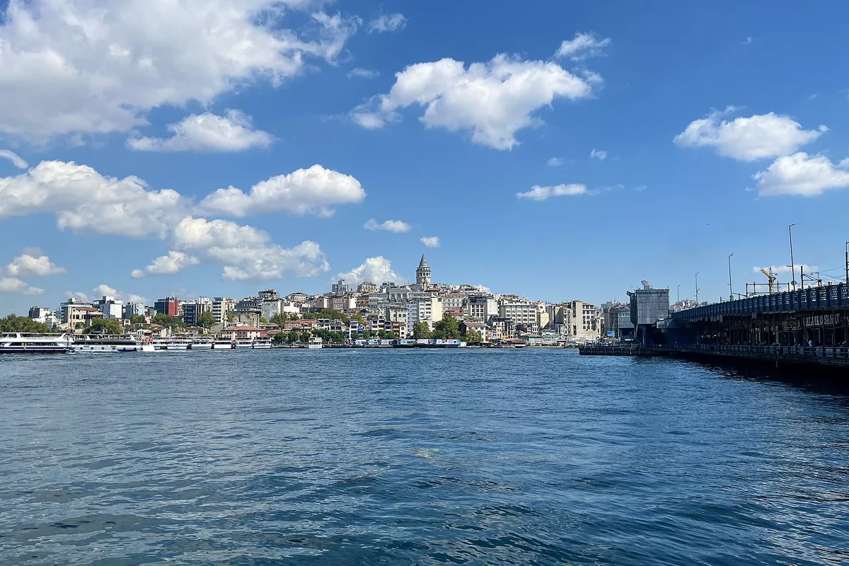 Galata hill and its tower seen across the Golden Horn from the Eminönü shore, with the Galata Bridge at the right.